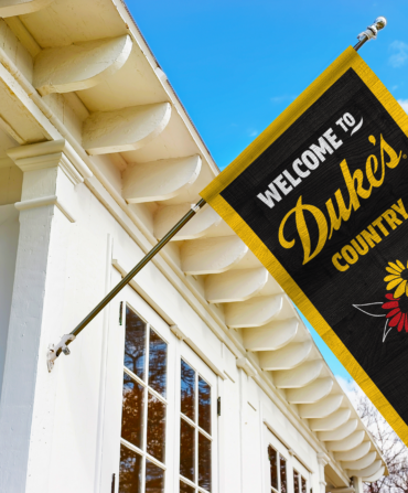 A Duke's Mayonnaise flag waving on the side of a house