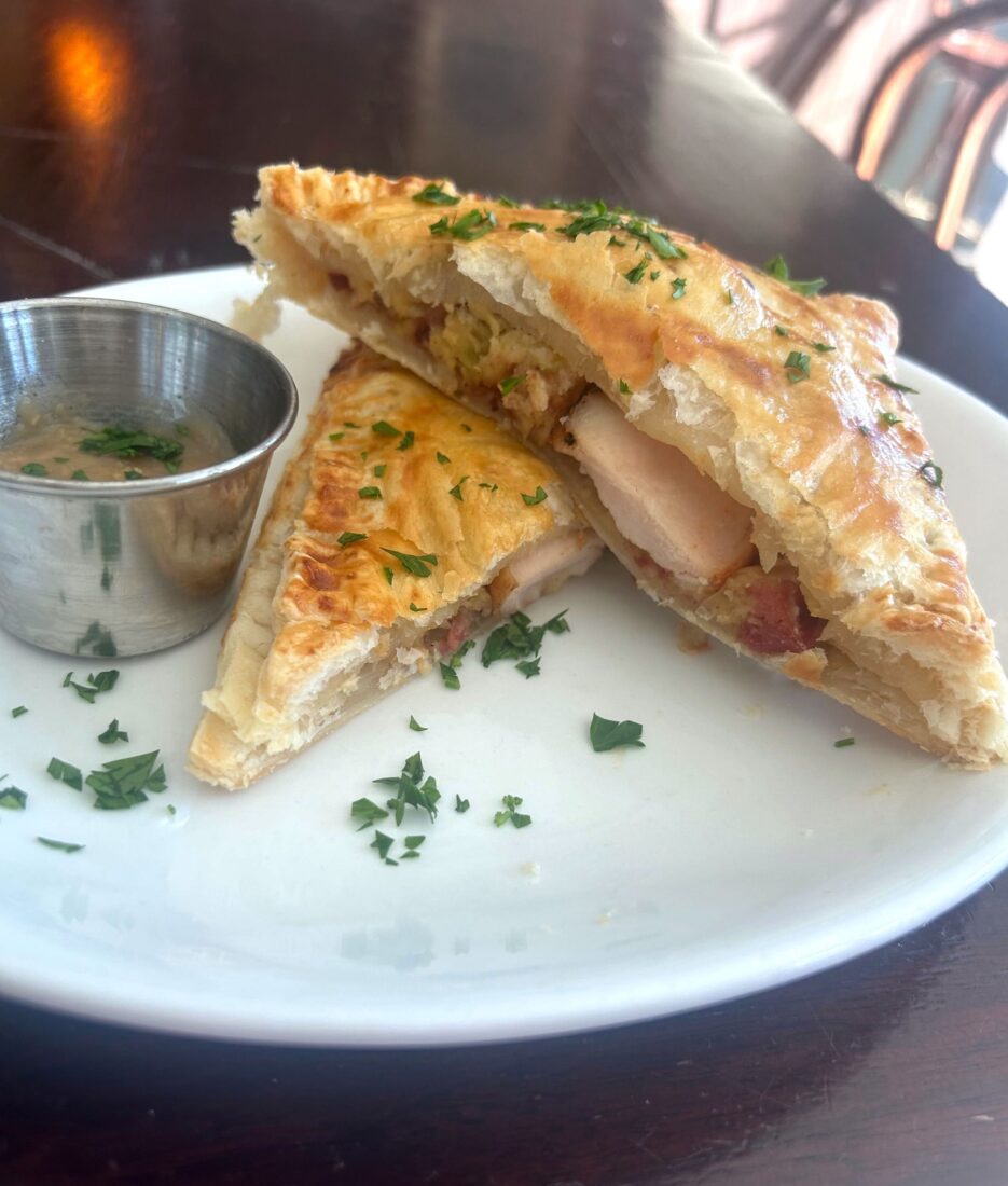 A slice of a thanksgiving hot pocket on a plate