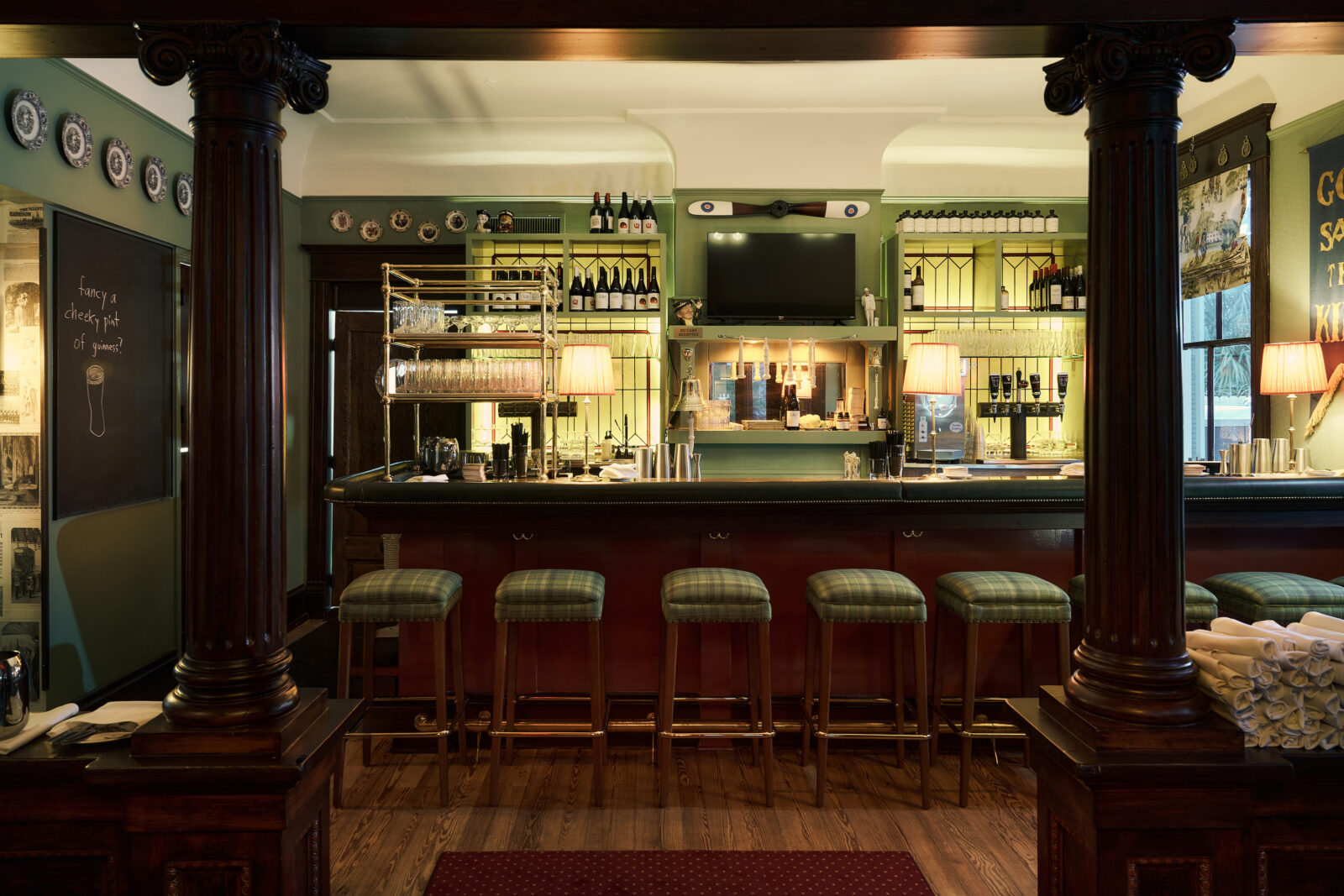 A bar top with tartan-plaid stools