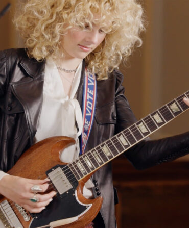 A woman playing a guitar