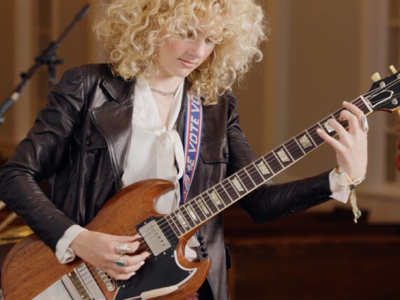 A woman playing a guitar