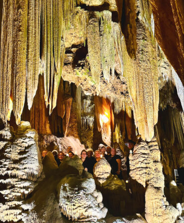 People carol inside a cavern