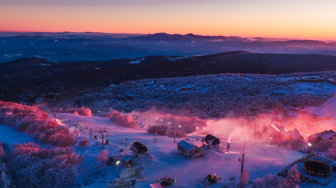 Sunset over a ski resort with a mountain vista