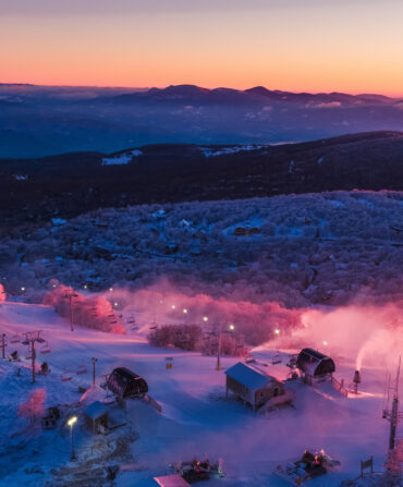 Sunset over a ski resort with a mountain vista