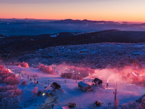 Sunset over a ski resort with a mountain vista