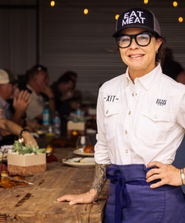 A chef stands at a table