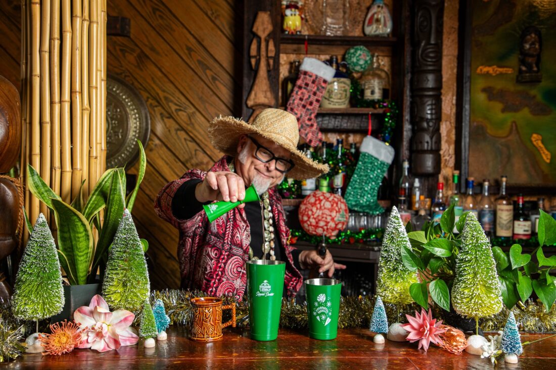 A man at a holiday bar pours a drink