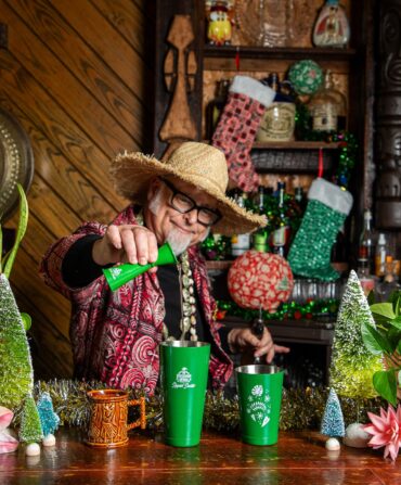 A man at a holiday bar pours a drink