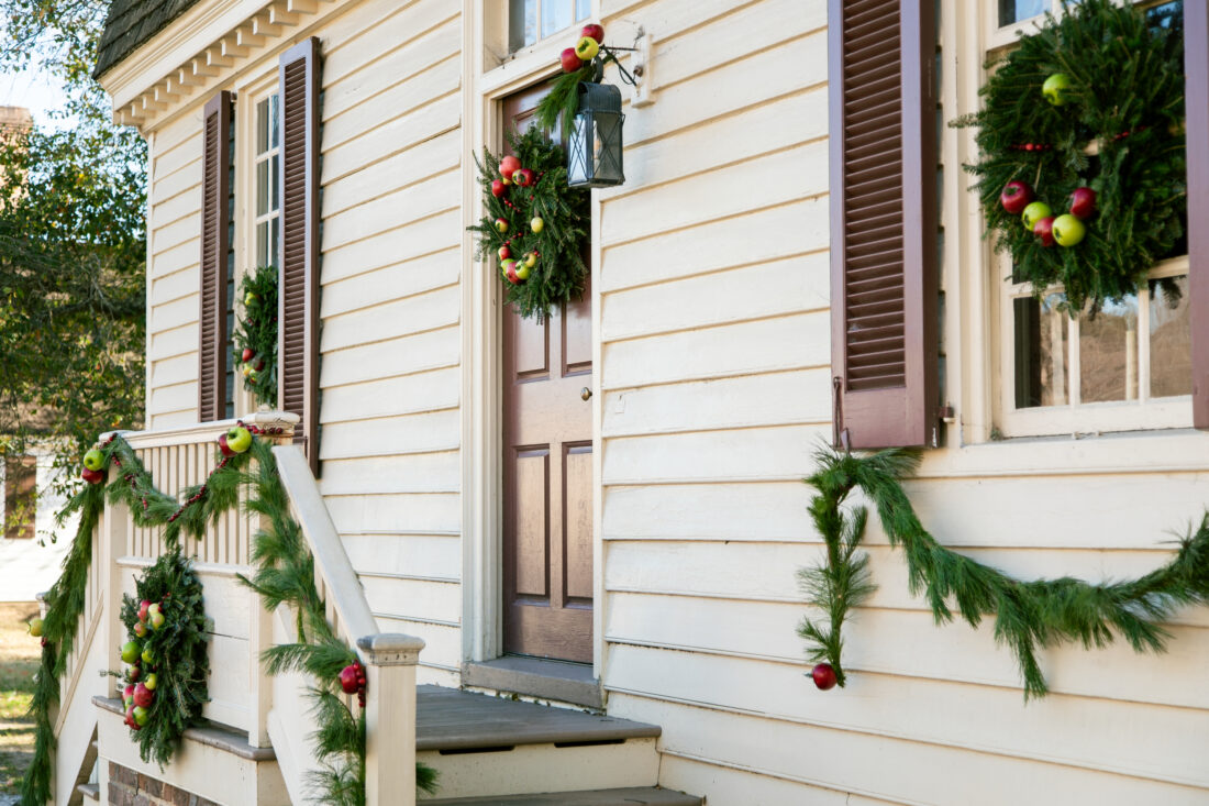 A white house decorated with wreaths for christmas