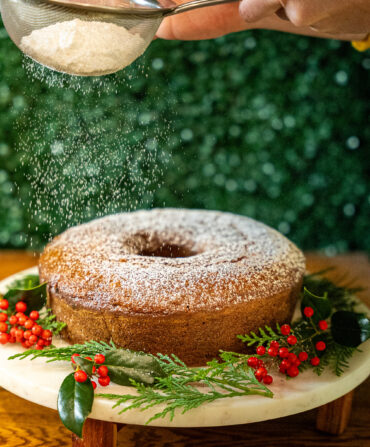 Dusting powdered sugar on a bunt cake