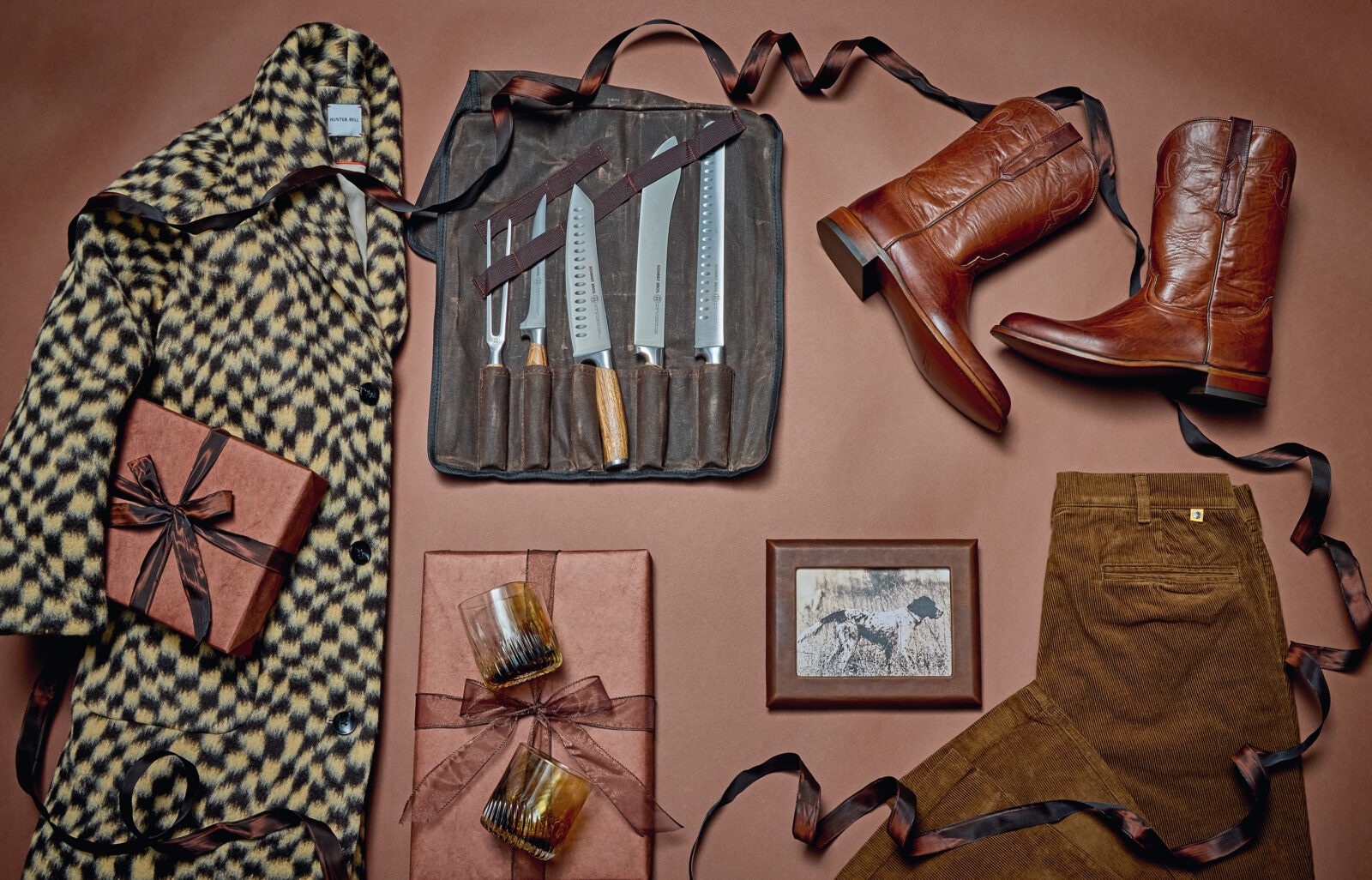 Clothes, boots, rocks glasses, and knives laid out