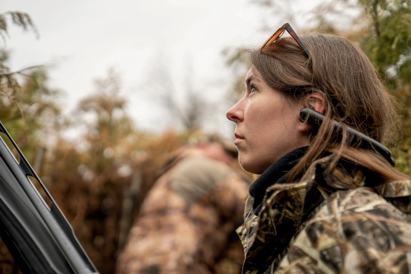 A woman sits in a duck blind