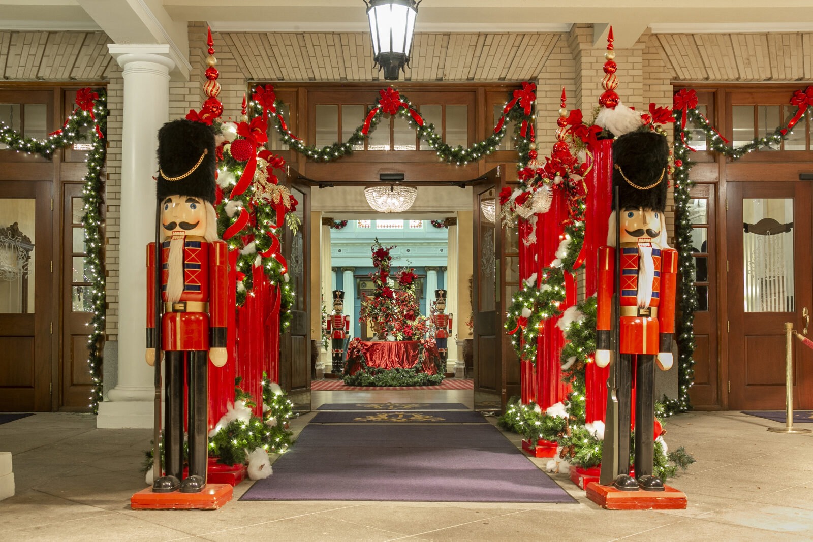 Nutcrackers stand outside a holiday-decorated hotel