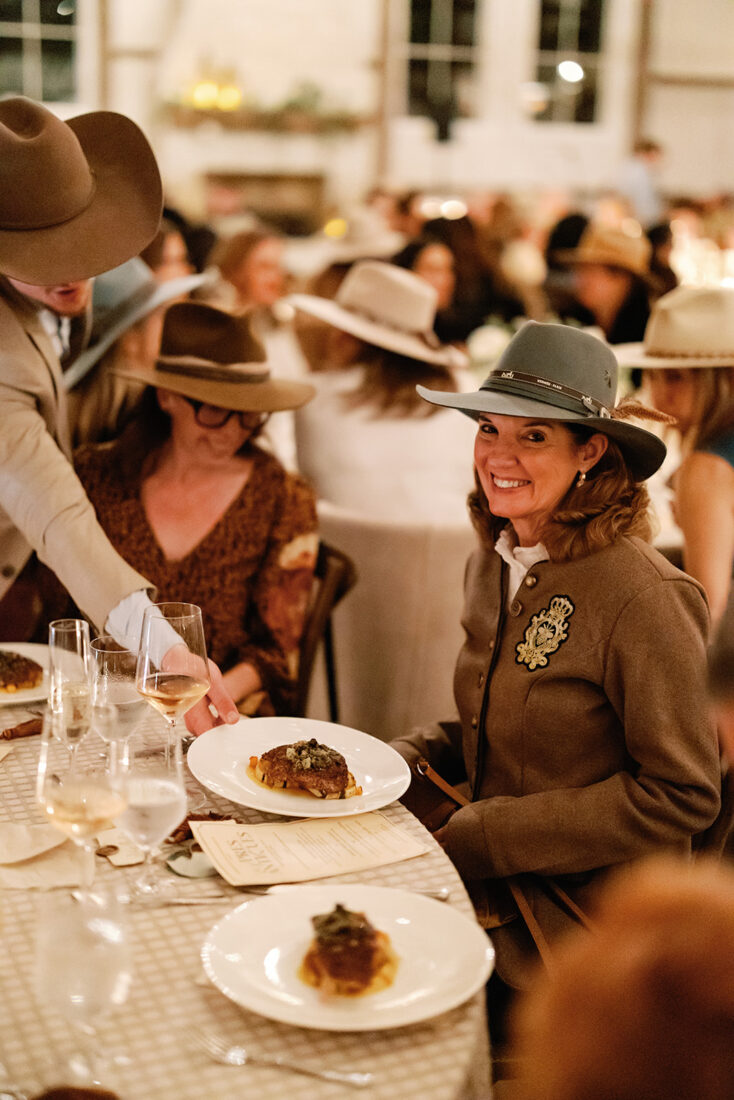 Betsy Austin receives her third course of Southern pecan-crusted red snapper served with brussels sprouts, roasted squash, and sauce meunière.