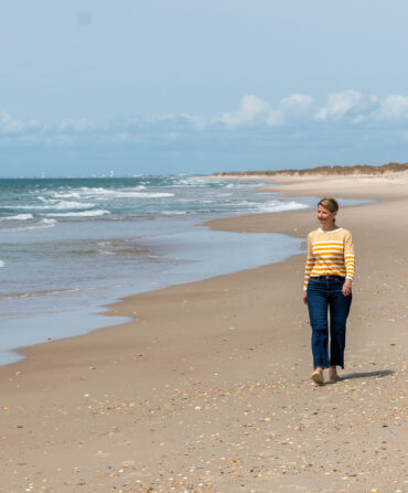 A woman walking along a beach