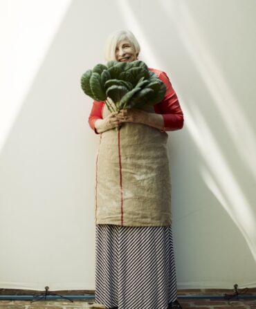 A portrait of Nathalie Dupree holding collards