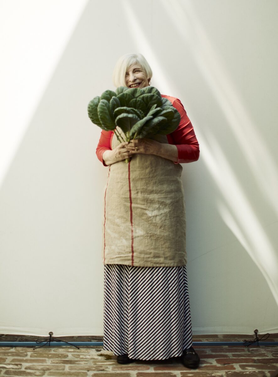 A portrait of Nathalie Dupree holding collards