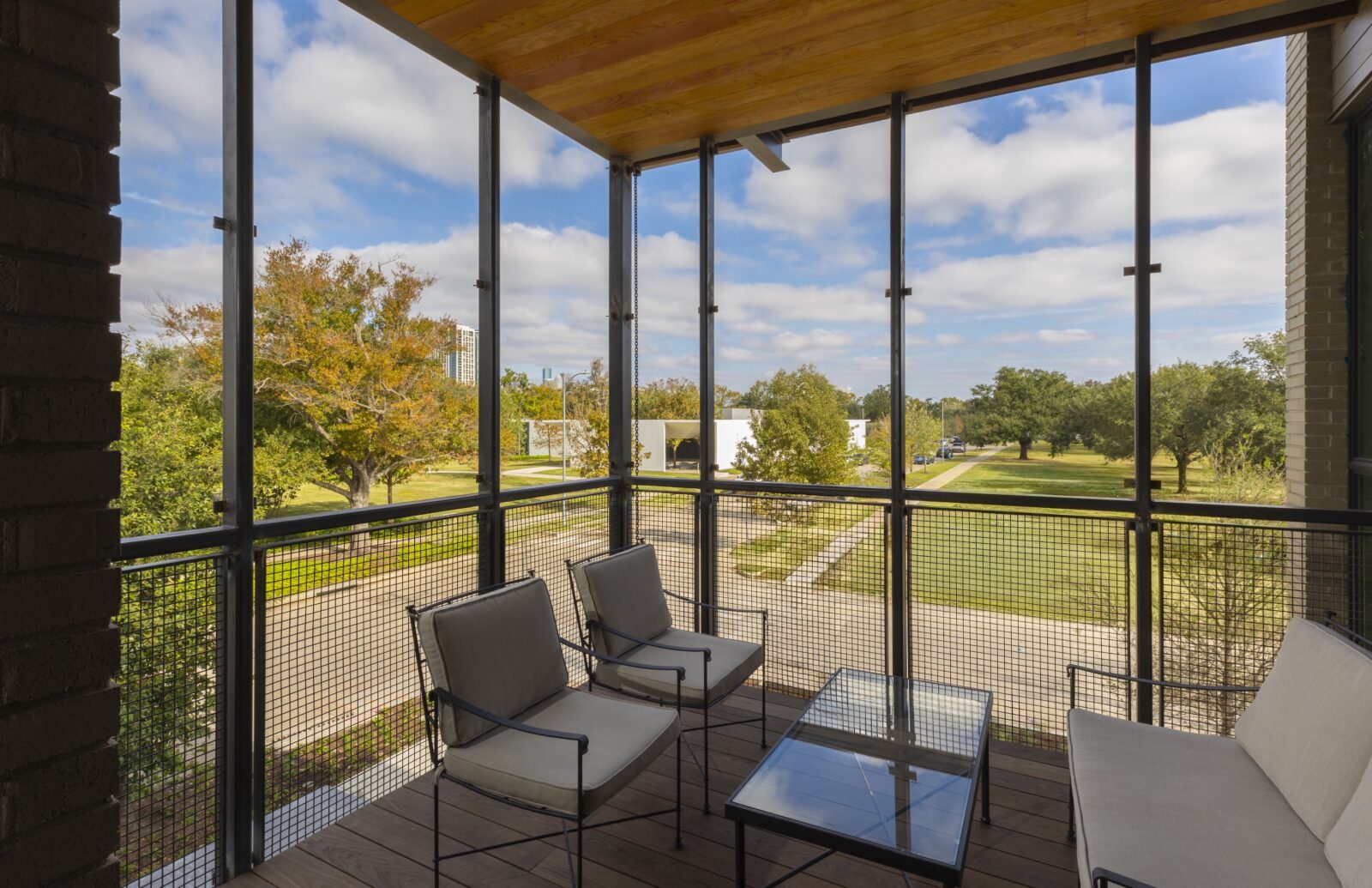 A screened-in porch overlooks a garden corutyard