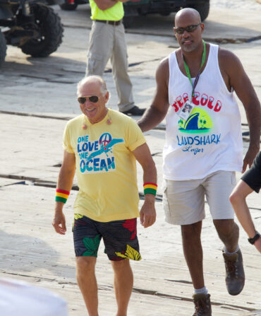 Jimmy Buffett and Charleston Miles walk down a sidewalk