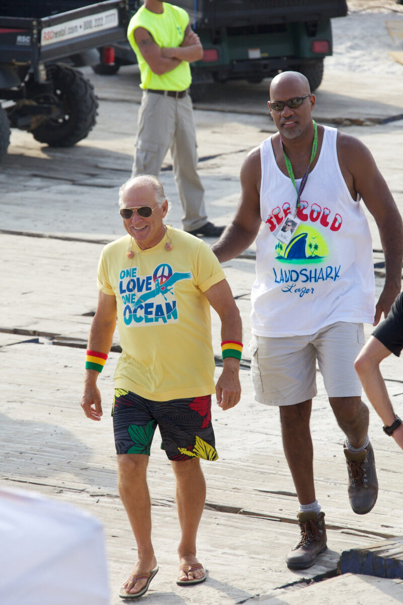 Jimmy Buffett and Charleston Miles walk down a sidewalk