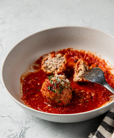 A bowl of meatballs in red sauce