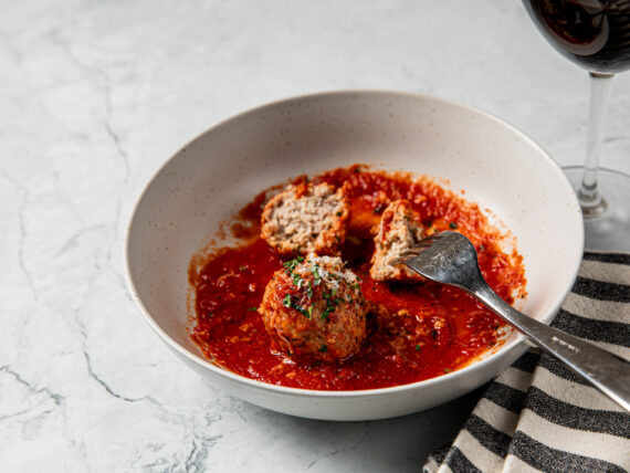 A bowl of meatballs in red sauce