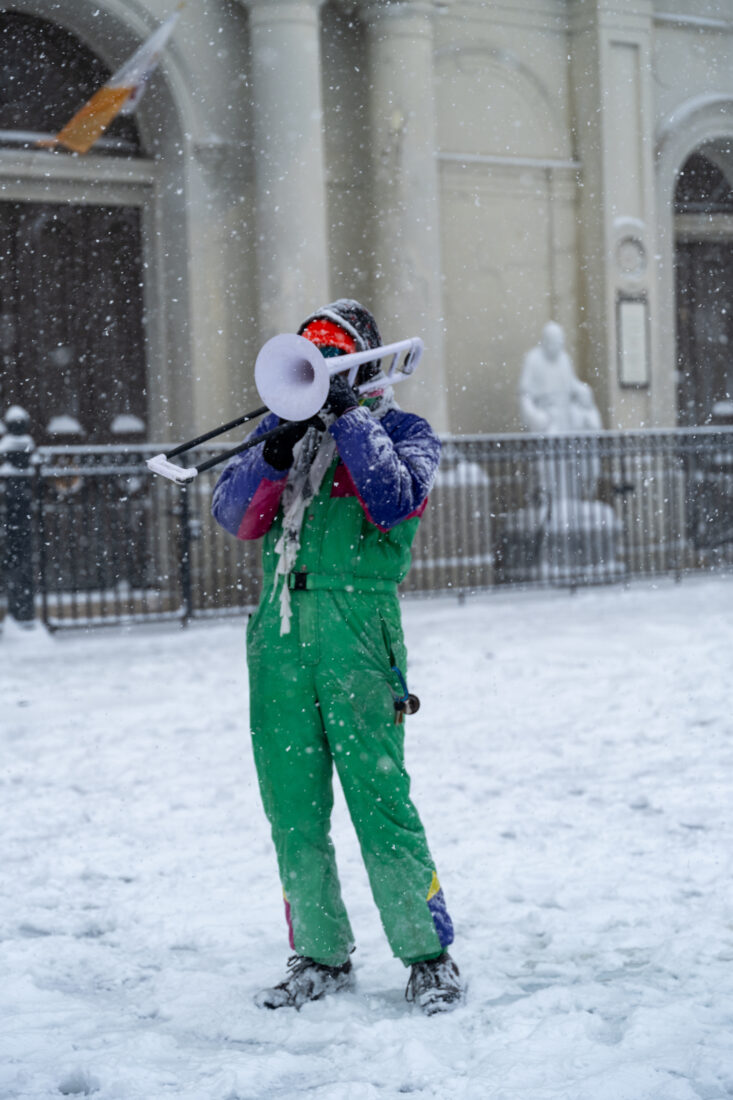 A trombone player performs in the snow