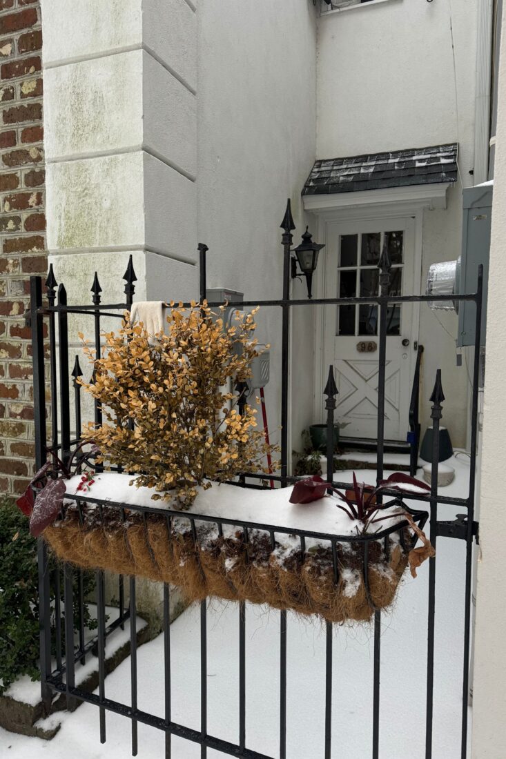 A flower planter covered in snow