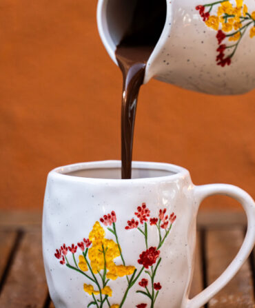 Hot chocolate pours into a mug