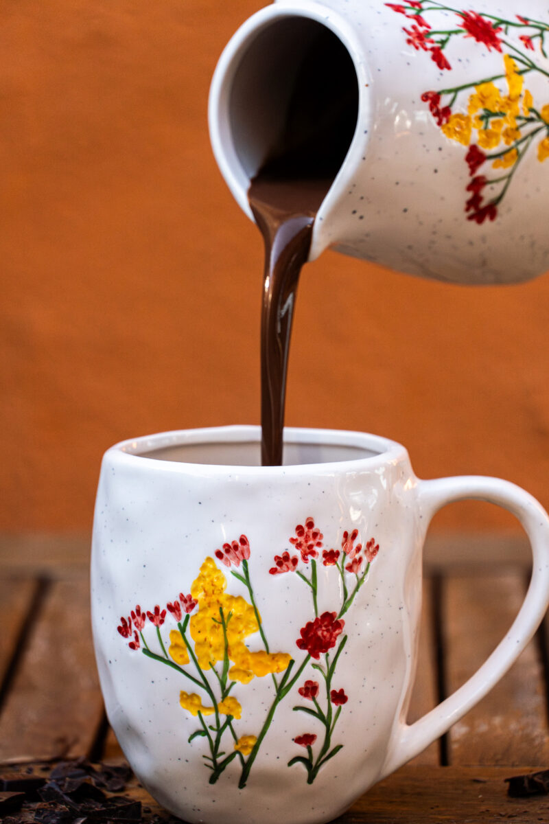 Hot chocolate pours into a mug
