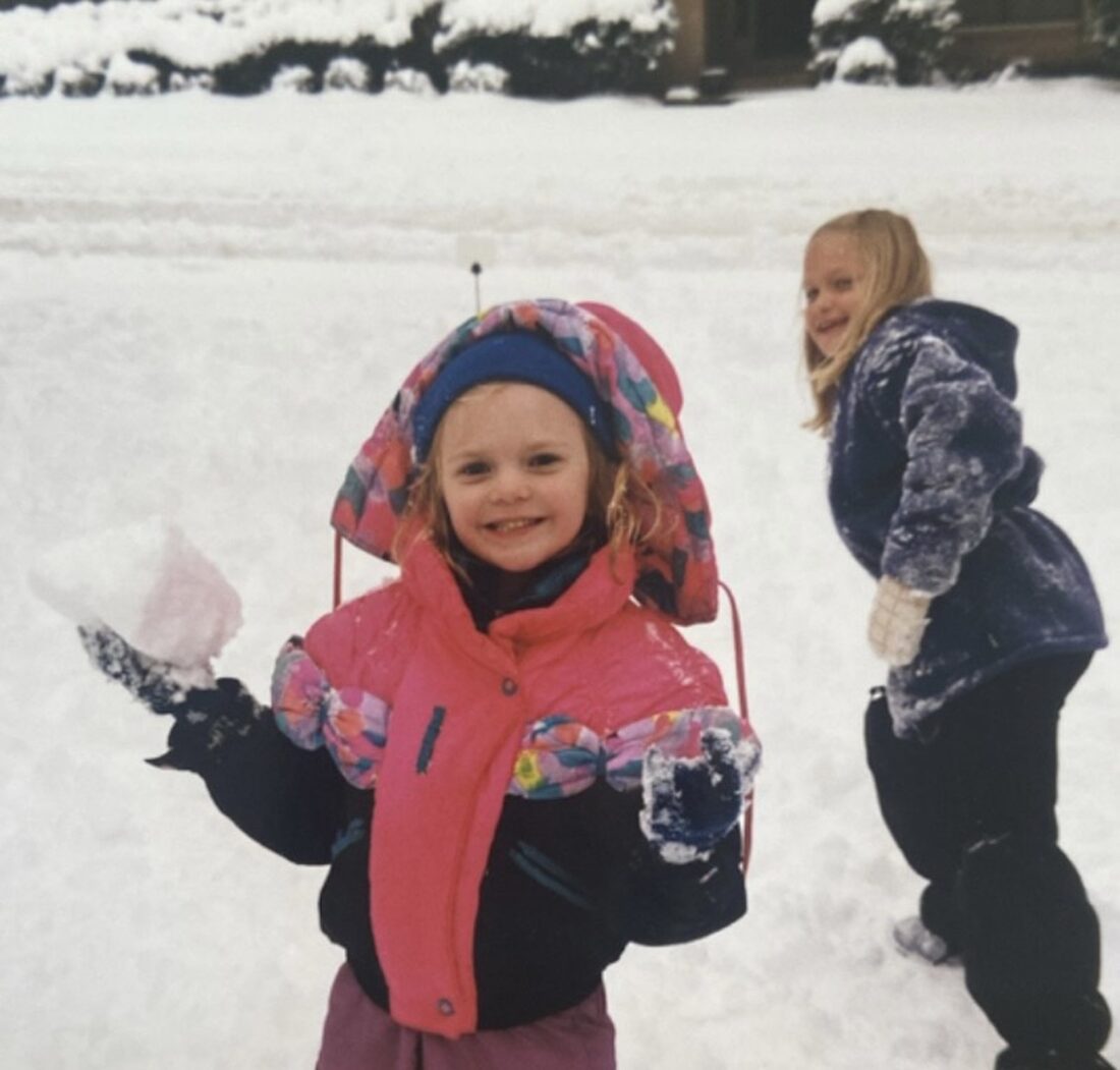 A vintage photo of a little girl in the snow