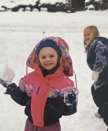 A vintage photo of a little girl in the snow