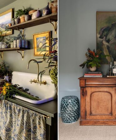 A kitchen sink with a curtain ruffle cover under it and flowers around it; a wood bureau with lamps on it