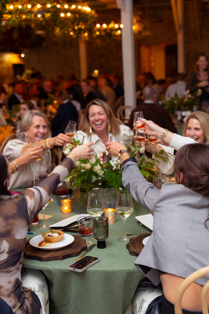 Guests raise glasses of Blade and Bow 22-year-old bourbon.