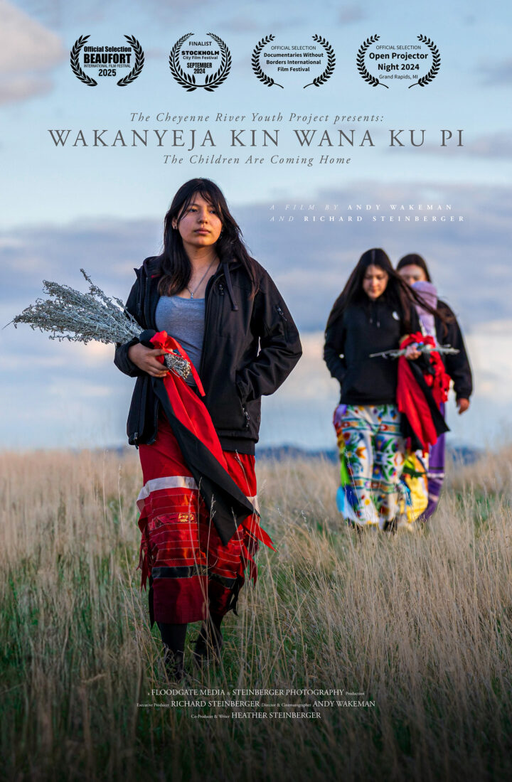 A movie poster showing three young people walking through a field