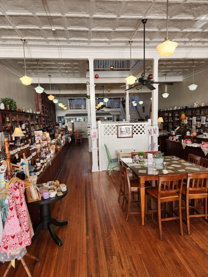 A wood-detailed tea room with shelves of provisions