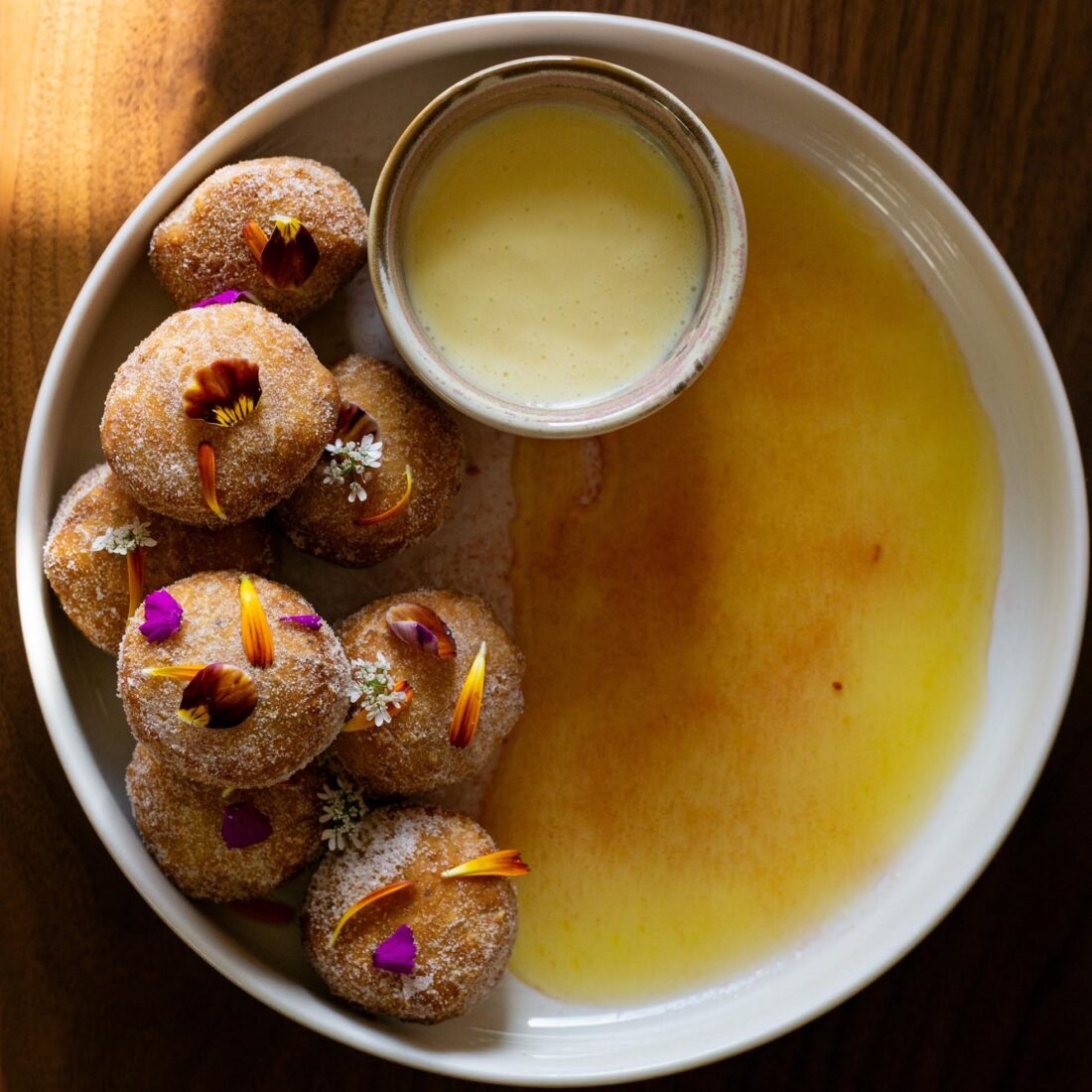 Beignets in a bowl with sauce