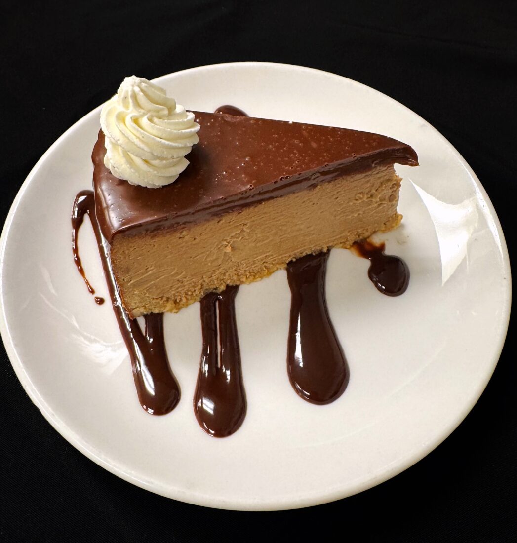 A slice of chocolate cheesecake on a plate
