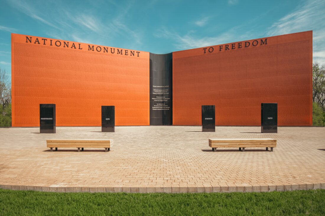 A wall-shaped monument, inscribed with approximately 122,000 names