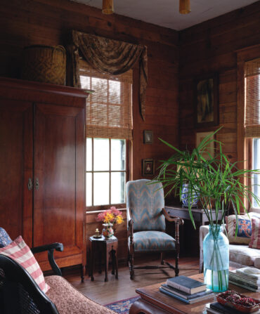 A wood-paneled sitting room with antique furniture