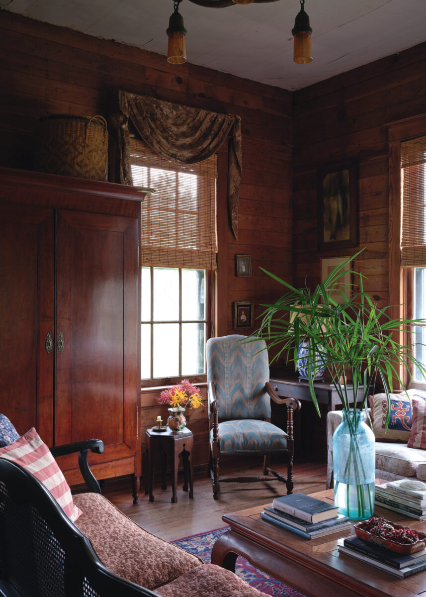 A wood-paneled sitting room with antique furniture