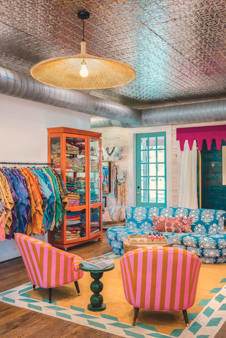 Inside a colorful shop with chairs and clothes