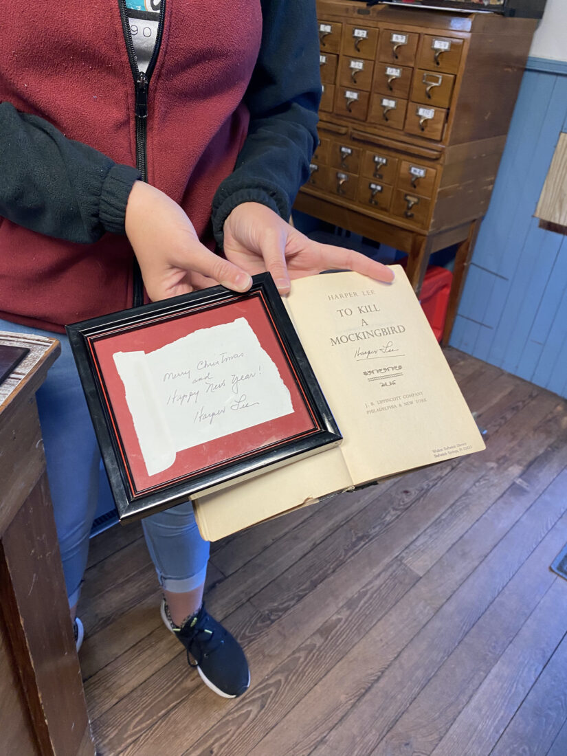 A person holds a signed first edition of To Kill a Mockingbird