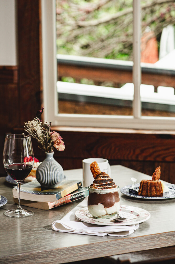 Plates of desserts and glasses of wine on a table