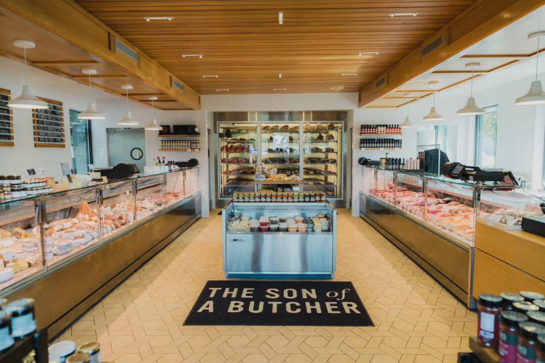 Inside a cheese shop with cases of cheese