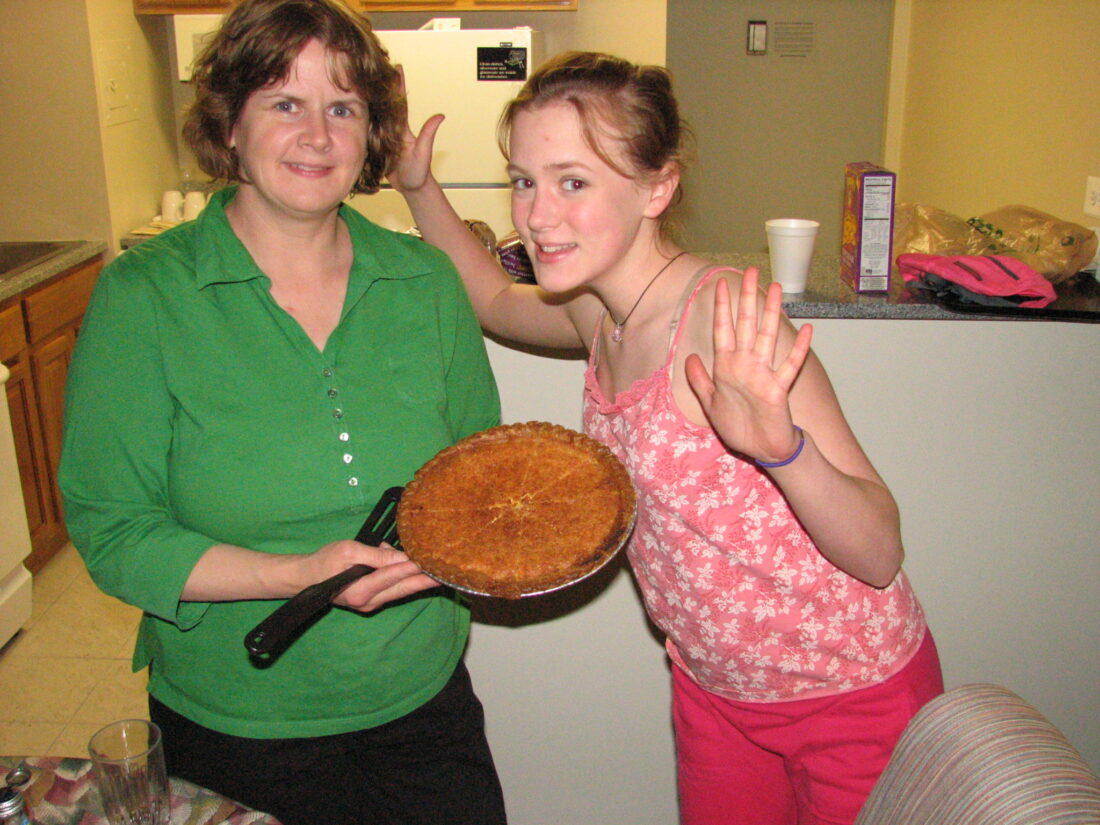 A girl and her mother pose for the camera with a lemon chess pie in a skillet