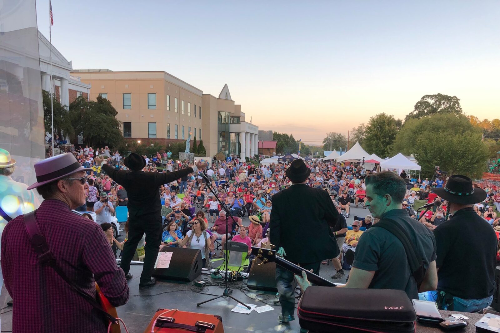 A crowd of people gather in front of a stage