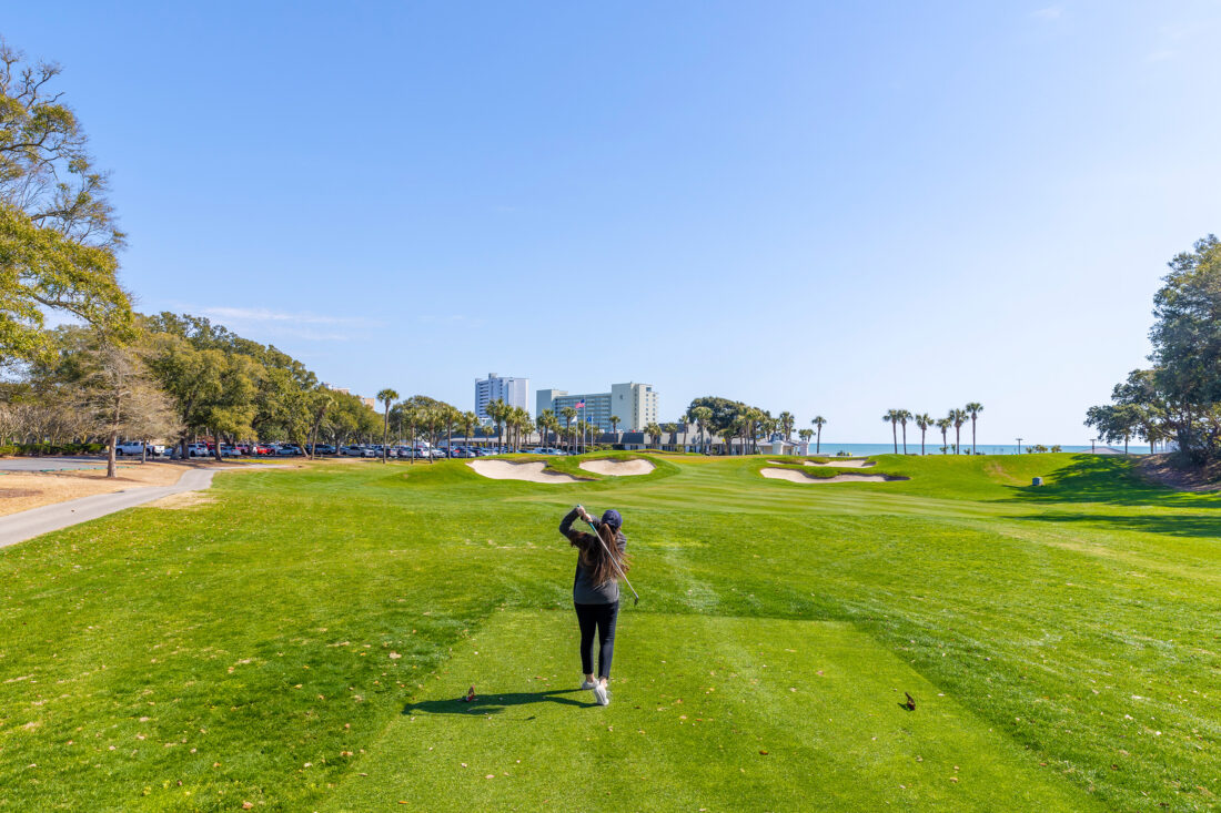 A woman playing golf