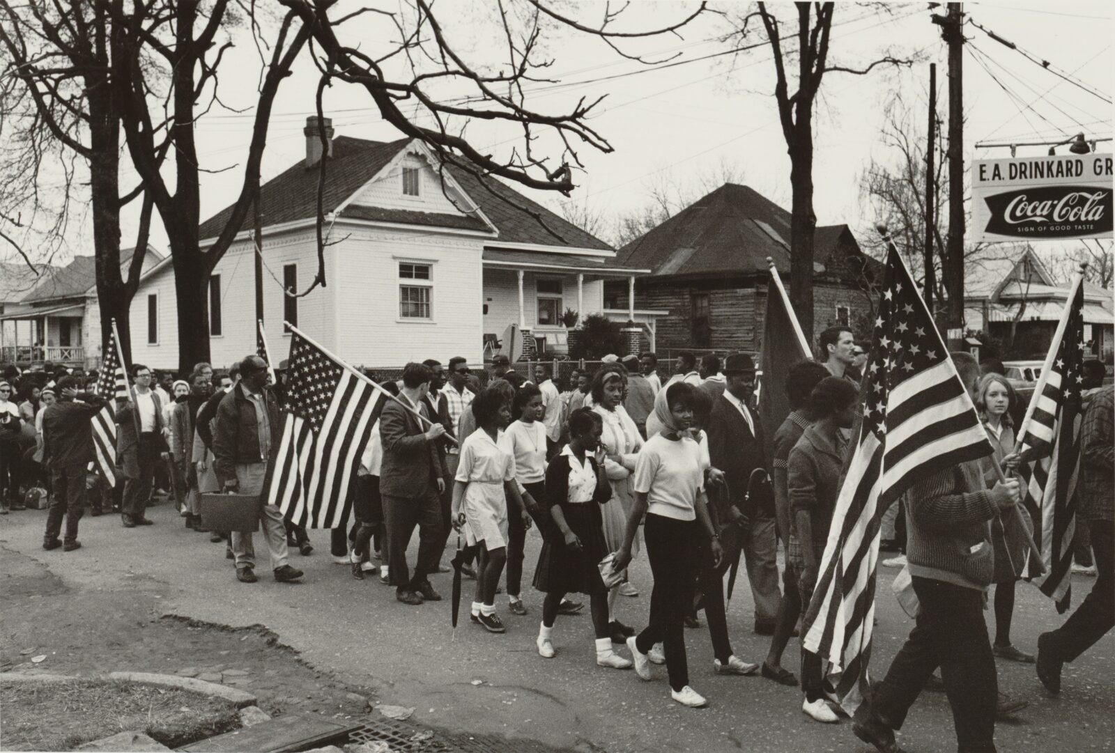 Civil rights activists march and carry American flags