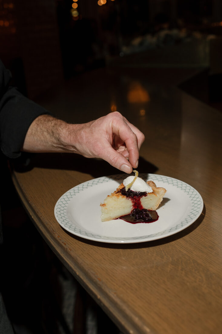 Doss garnishes the dessert course: buttermilk pie with blueberry preserves.